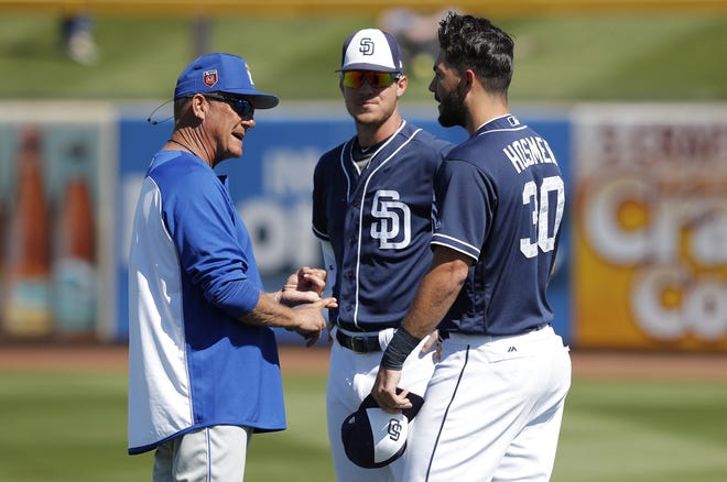 Kansas City vice president of baseball operations George Brett, left, talks with San Diego's Eric Hosmer, right, and Wil Myers before Friday's game. Hosmer was a key part of the Royals' 2015 World Series championship team. [Charlie Neibergall/The Associated Press]