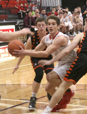 Hiland senior Scott Troyer splits the Shadyside defense on his way to a first half bucket. Troyer hit three third-quarter 3-pointers en route to 19 points to lead the Hawks past the Tigers.