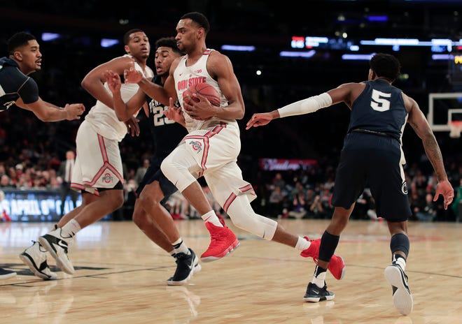 Ohio State forward Keita Bates-Diop, center, drives to the basket against Penn State during the first half of an NCAA Big Ten Conference tournament college basketball game, Friday, in New York.