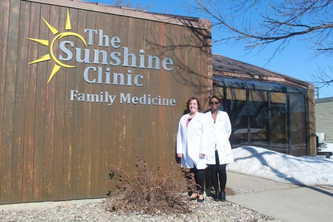 Stephanie Buckmier, NP, and Dr. Rita Nalubega, MD FAAFP (Family Practice) pose outside The Sunshine Clinic.