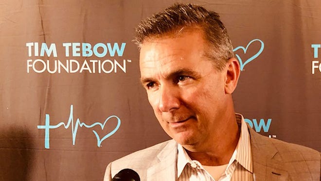 Ohio State coach Urban Meyer talks to the media on the red carpet of the Tim Tebow Foundation Celebrity Gala on Friday at the TPC Sawgrass. [Garry Smits/The Times-Union].
