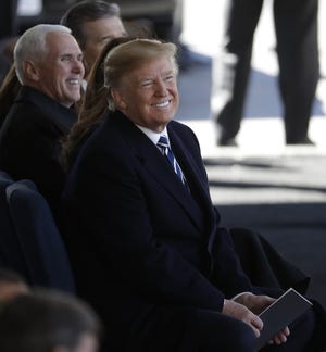 President Donald Trump and Vice President Mike Pence react to a light moment during a funeral service at the Billy Graham Library for the Rev. Billy Graham, who died last week at age 99, Friday, March 2, 2018, in Charlotte, N.C. (AP Photo/Chuck Burton)