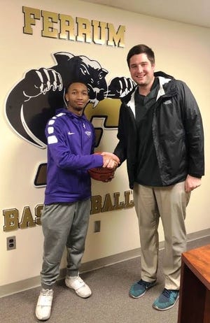Stuart Cramer's Dezure Moulden shakes hands with Ferrum head coach Tyler Sanborn after committing to play for the Panthers next season. [Provided photo]