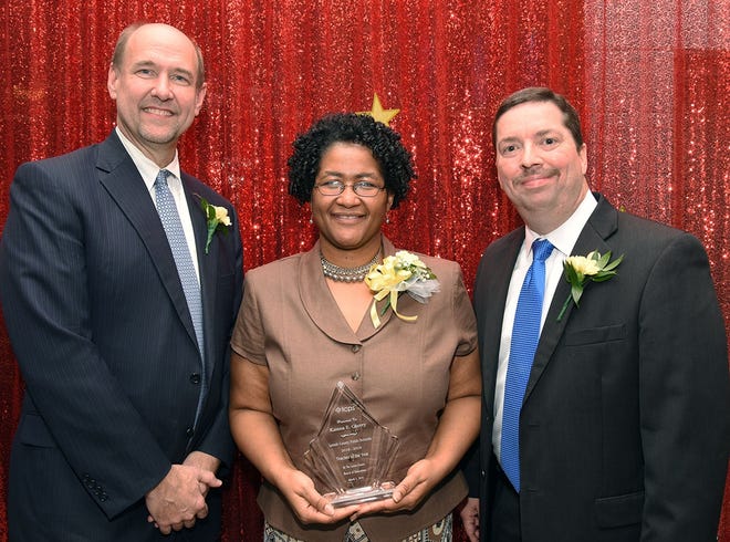 Lenoir County Public Schools Teacher of the Year Katena Cherry accepts her award with Superintendent Brent Williams and Board of Education Chairman Jon Sargeant. [Patrick Holmes/Contributed photo]