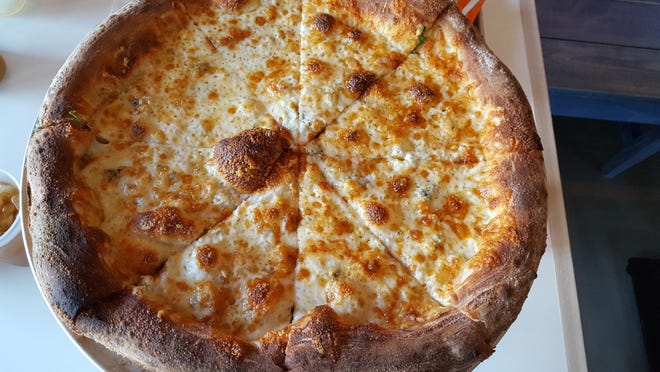 Quartro Formaggio (four cheeses) is a specialty pizza at Southside Slice with garlic oil, mozzarella, white cheddar, asiago and gorgonzola cheeses. [BRENDA SHOFFNER/DAILY NEWS]