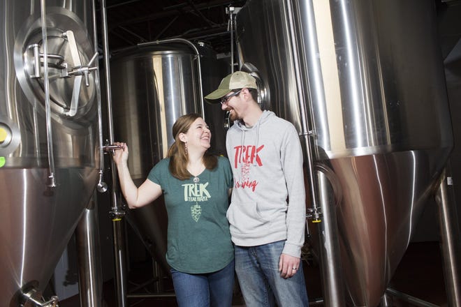 John and Kristin Ream stand in front of their ferementers in the back room of their new brewery, called "Trek Brewing Company," in Newark. The Reams moved from Seattle to raise their two sons and begin their business close to family. [Brooke LaValley/Dispatch]