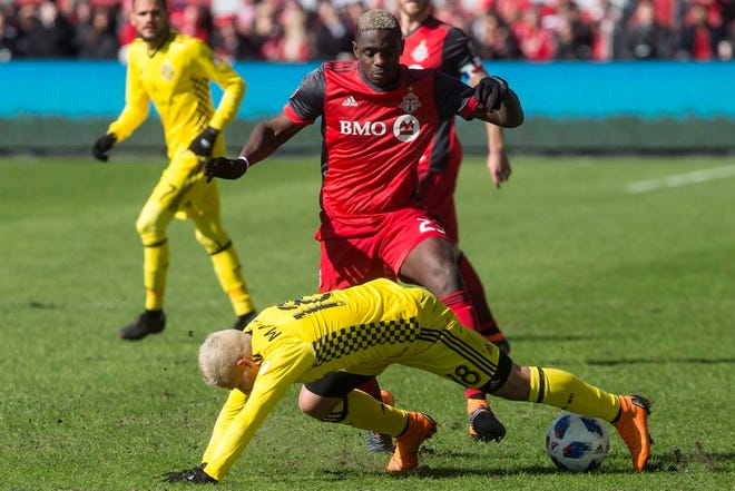 Columbus Crew's Cristian Martinez and Toronto FC's Chris Mavinga vie for the ball during the second half of an MLS soccer game in Toronto on Saturday, March 3, 2018.