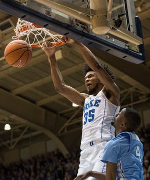 Duke's Marvin Bagley III (35) dunks over North Carolina's Brandon Robinson (4) during the first half of an NCAA college basketball game in Durham, N.C., Saturday, March 3, 2018. (AP Photo/Ben McKeown)