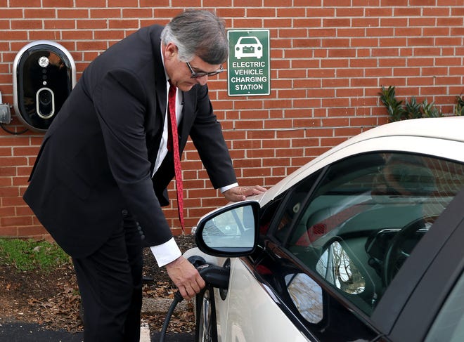 Ronnie Lineberger plugs his 2013 Chevrolet Volt into the electric vehicle charging station behind his Mount Holly business. [JOHN CLARK/THE GASTON GAZETTE]