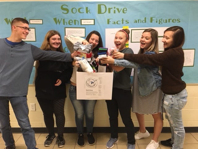 Members of the Lakewood chapter of the National Honor Society check out the donation box at Lakewood High School. Their sock drive runs through March 9. [Contributed]