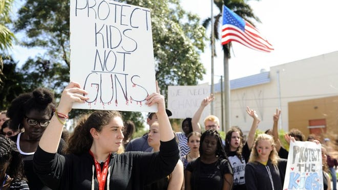 G Star School of the Arts students participate in a walkout from school in protest of gun violence Wednesday Feb. 21, 2018 in West Palm Beach. “It is ridiculous that we have to be out here protesting gun violence,” said student Zoe Overholser, 16. The students stood in front of the school and observed 17 minutes of silence for each of the Marjory Stoneman Douglas High School shooting victims. (Meghan McCarthy / The Palm Beach Post)