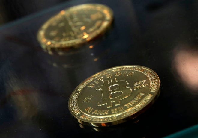 Coins are displayed next to a Bitcoin ATM in Hong Kong. If the stolen equipment is used for its original purpose — to create new bitcoins — the thieves could turn a massive profit in an untraceable currency without ever selling the items.