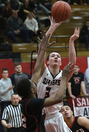 Nate Voll of New Philadelphia shoots over Joshua Zimmerman of Steubenville in the Division II sectional final Saturday. (timesReporter.com / Jim Cummings)