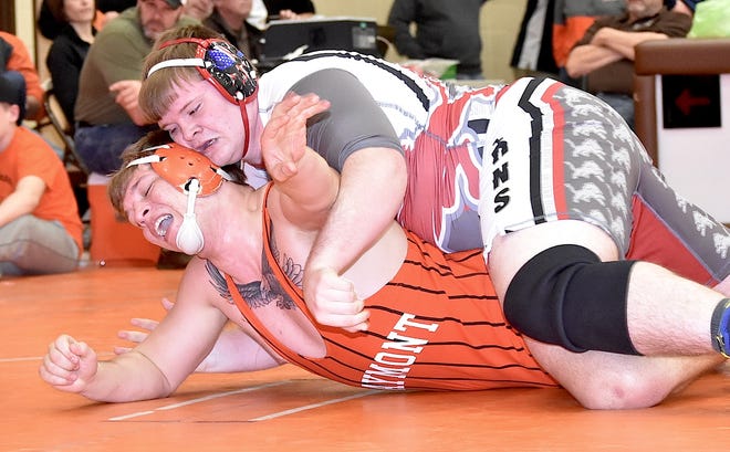 Minerva heavyweight Travis Kuttler (on top) applies some pain to Claymont's Lyle Clark. Kuttler won the third-place district match 6-3, qualifying to his first state championships.
