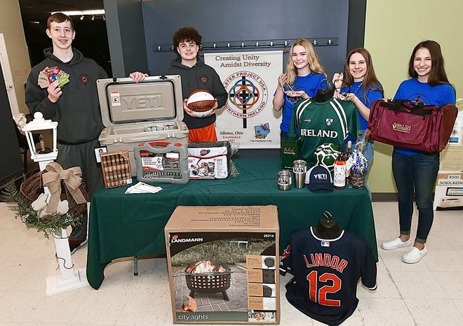 Aiden Trummer, Macagey Laure, Ella Dipold, Carley Andrews and Olivia Ryan show off the fundraiser items for the Alliance Area Ulster Project's annual auction to be held March 10.