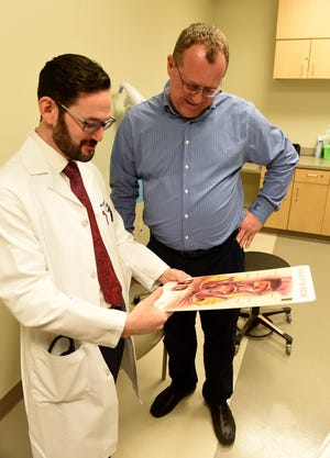 Colorectal surgeon Avi Galler, at the Virtua Surgical Group in Moorestown, talks with patient Shawn Ryan, of Evesham, about colon cancer. Ryan had colon cancer in November 2015 and Galler was the doctor who handled his surgery. [CARL KOSOLA / STAFF PHOTOJOURNALIST]