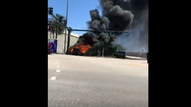 A person was seriously injured after crashing into a pole on Palm Beach Lakes Boulevard, with the car catching on fire. (Credit: Greg Dwornitski)