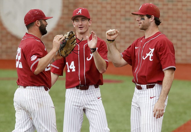 Alabama infielder Hunter Alexander (22) is welcomed to the dugout after making a catch to end an inning by teammates Alabama outfielder Gene Wood (14) and Alabama outfielder Keith Holcombe (18) at Sewell-Thomas Stadium Wednesday, Feb. 28, 2018. [Gary Cosby Jr./Staff Photo]