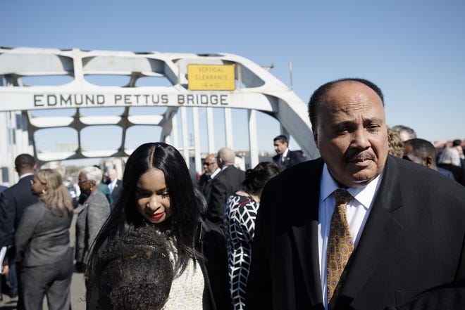 Martin Luther King III stands on the Edmund Pettus Bridge on Sunday, March 4, 2018, in Selma during the annual commemoration of "Bloody Sunday," the day in 1965 when voting rights protesters were attacked by police as they attempted to cross the Edmund Pettus Bridge. [Albert Cesare/The Montgomery Advertiser via AP]