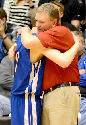 Hanover coach Kim Lohse hugs senior WIll Bruna in the closing moments of the 2017 Class 1A Division I state championship game against South Gray in Hays. [NICK SCHWEIN/HAYS DAILY NEWS]