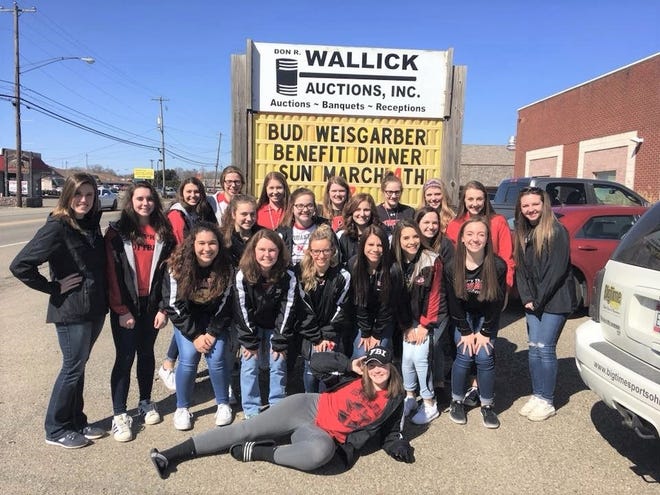 Members of the New Philadelphia High School softball team pose in front of the Don Wallick’s Auction Center in Strasburg after the Bud Weisgarber Benefit Dinner on Sunday. The Quakers are coached by former Strasburg standout Karly (DiBacco) Ross. Submitted photo.