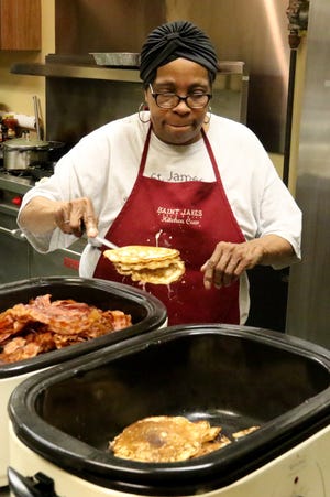 Anna Jones adds more pancakes for filling breakfast orders during the Mercy Outreach Center at St. James Baptist Church's Pancake Breakfast in the church fellowship hall Saturday, March 3, 2018. The fundraising event was for the Gary L. Hinkle tutoring program, which tutors more than 40 students after school and includes all grades. [JAMIE MITCHELL/TIMES RECORD]