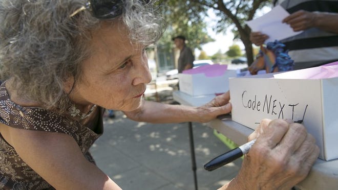 Linda Curtis, petition manager and founder of IndyAustin, is shown last fall preparing handouts for a petition drive to hold a voter referendum on CodeNext. RALPH BARRERA / AMERICAN-STATESMAN