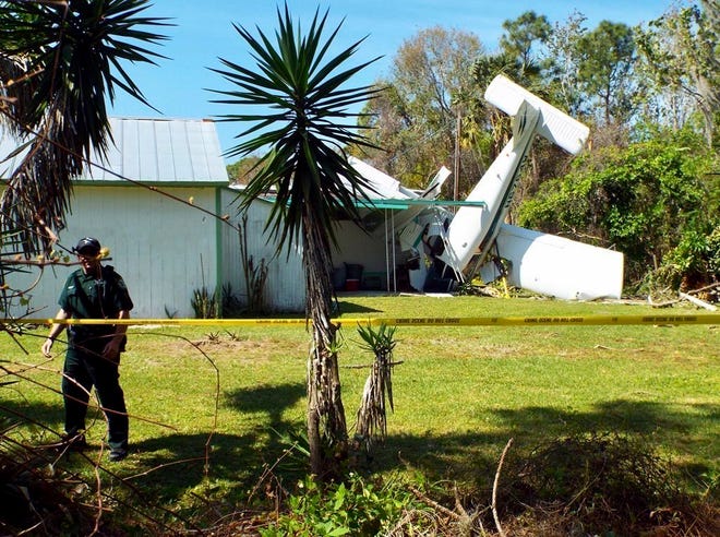 A small aircraft crashed Tuesday, March 6, 2018, through some trees and into the backyard of a home at 1049 Roberts Lane, in New Smyrna Beach near the Edgewater, Fla., city limit. (Patricio G. Balona/The Daytona Beach News-Journal via AP)