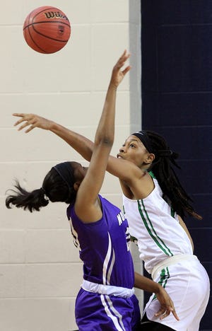 Evonna McGill blocks a shot by Northern Guilford's Janelle Henderson during Ashbrook's 51-43 loss in the 3A Western Regional Final last Saturday at UNC Greensboro. [JOHN CLARK/THE GASTON GAZETTE]