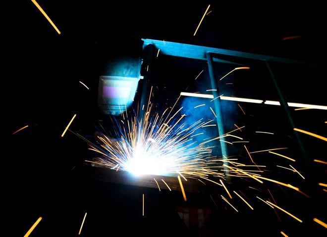 A welder fabricates a steel structure at an iron works facility in Ottawa, Ontario, Monday, March 5, 2018. (Sean Kilpatrick/The Canadian Press via AP)