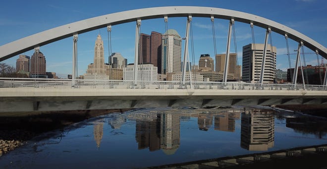 Downtown buildings are reflected in a partially frozen Scioto River. This vantage point is just south of the Main St. bridge. [Doral Chenoweth III/Dispatch]