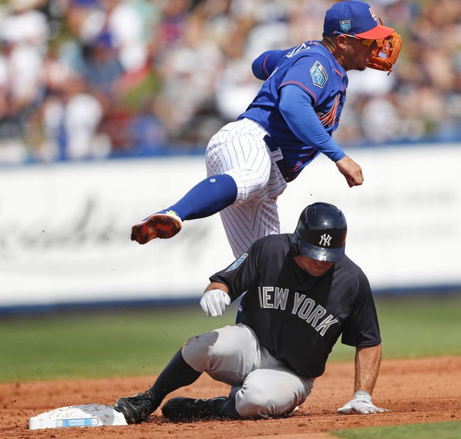 Mets second baseman Asdrubal Cabrera avoids Yankees' Brett Gardner as he turns a double play on a Brandon Drury ground ball in the third inning of Wednesday's game in Port St. Lucie, Fla. [The Associated Press]
