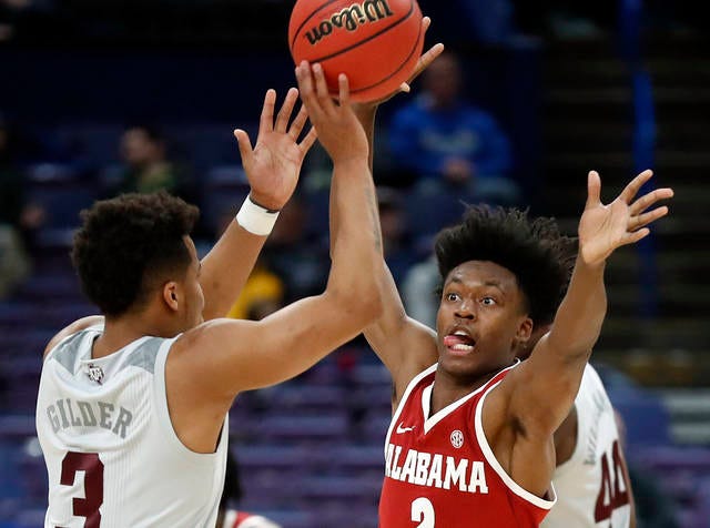Alabama freshman guard Collin Sexton, defending Texas A&M’s Admon Gilder, scored the gamewinning basket in the Tide’s 71-70 SEC Tournament victory Thursday. Sexton scored a game-high 27 points in the win, sending the ninth-seeded Tide into a Friday quarterfinal against top seed Auburn. (Jeff Roberson/The Associated Press)