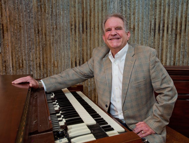 Randy Grimes, co-owner of High Rock Outfitters, sits at his personal 1953 Hammond B3 organ. [Donnie Roberts/The Dispatch]