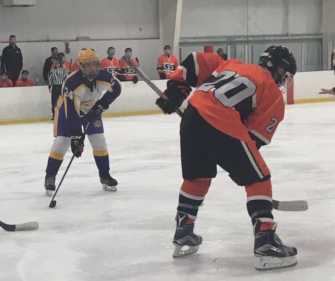 Junior Alexei Kowallis, right, lines up during a Cathedral Prep hockey game. [CONTRIBUTED PHOTO]
