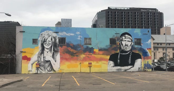 Austin icons Janis Joplin and Willie Nelson keep watch over a parking lot in downtown Austin. [Photo by Rick Holmes]
