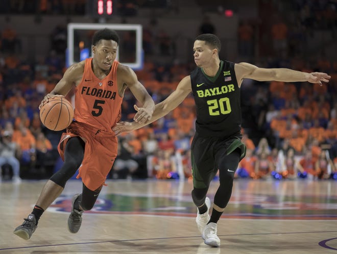Florida guard KeVaughn Allen (5) dribbles past Baylor guard Manu Lecomte during the second half of a game Jan. 27 in Gainesville. [AP Photo/Ron Irby]