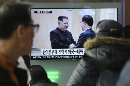 People watch a TV screen showing North Korean leader Kim Jong Un, left, meeting with South Korean National Security Director Chung Eui-yong in Pyongyang, North Korea, at the Seoul Railway Station in Seoul, South Korea, Wednesday. [ASSOCIATED PRESS/AHN YOUNG-JOON]