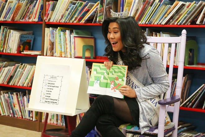 Katie Schreckengast, Miss Pennsylvania 2017, reads to a group of children at the Alexander Hamilton Memorial Free Library Wednesday afternoon. JOHN IRWIN/THE RECORD HERALD