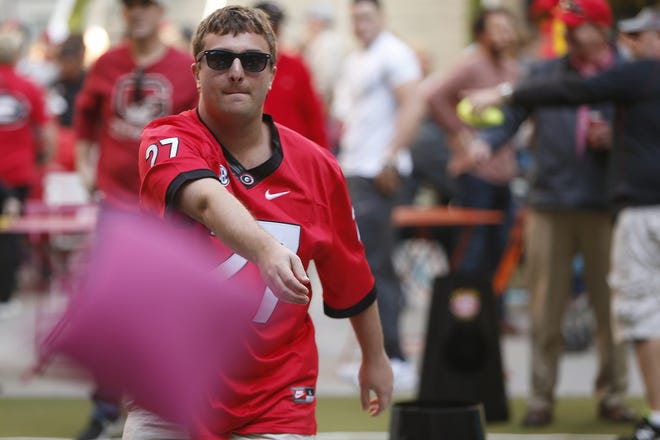 A Georgia fan has some fun playing cornhole at the Rose Bowl Bash in Los Angeles, on Sunday, Dec. 31, 2017. (Joshua L. Jones/Athens Banner-Herald)
