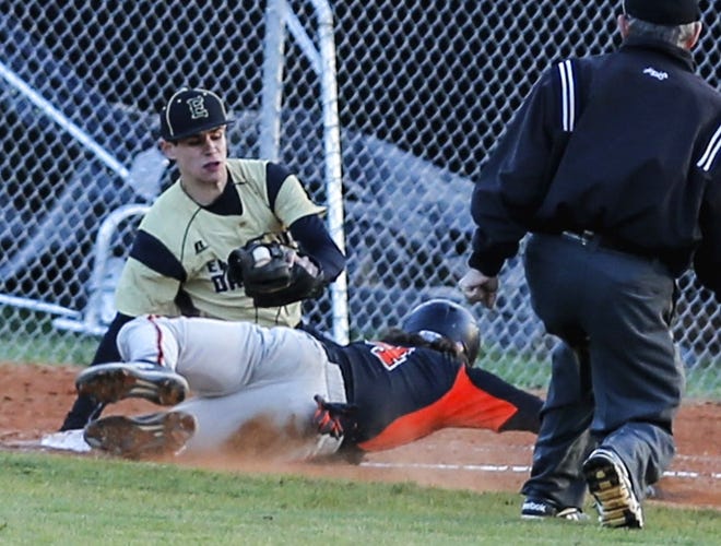 East Davidson third baseman Landon Albertson tags out North Davidson's Carson Simpson in Friday's game at East. [Michael Coppley for The Dispatch]