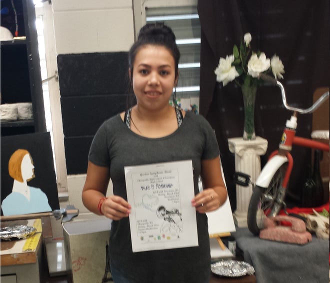 Itzel Diaz, a senior at Cherryville High School, holding her award winning entry in the Gaston Symphonic Band's Poster Design Contest. [PHOTO COURTESY OF BOB LOWDER]