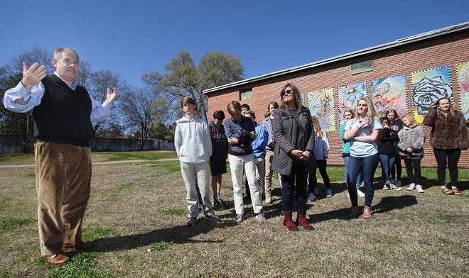Property owner Jonathan Taylor talks about the Gaston Day School art mural project after the school unveiled the mural which they created for the Belmont Community Gardens on Friday. [Mike Hensdill/The Gaston Gazette]