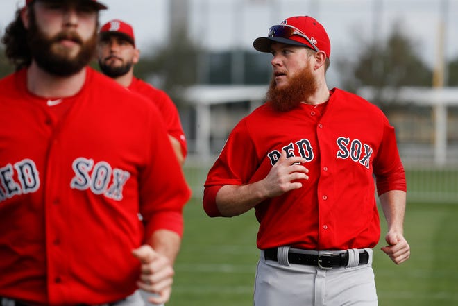 Red Sox closer Craig Kimbrel, right, warms up during spring training last month in Fort Myers, Fla. He's been throwing while back in Boston to be with his daughter who recently underwent surgery.