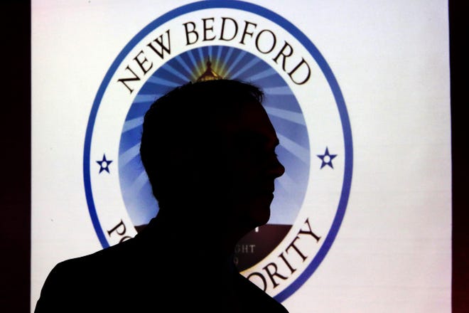 Mayor Jon Mitchell is silhouetted by the projection of the new New Bedford Port Authority logo on Wednesday. 

[ PETER PEREIRA/THE STANDARD-TIMES/SCMG ]