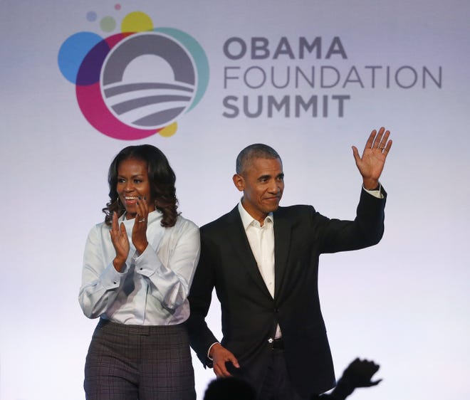 FILE - In this Oct. 13, 2017 file photo, former President Barack Obama, right, and former first lady Michelle Obama arrive for the first session of the Obama Foundation Summit in Chicago. Barack Obama and Netflix reportedly are negotiating a deal for the former president and his wife, Michelle, to produce shows exclusively for the streaming service. The proposed deal was reported Friday, March 9, 2018, by The New York Times, which cited people familiar with the discussions who were not identified. (AP Photo/Charles Rex Arbogast, File)