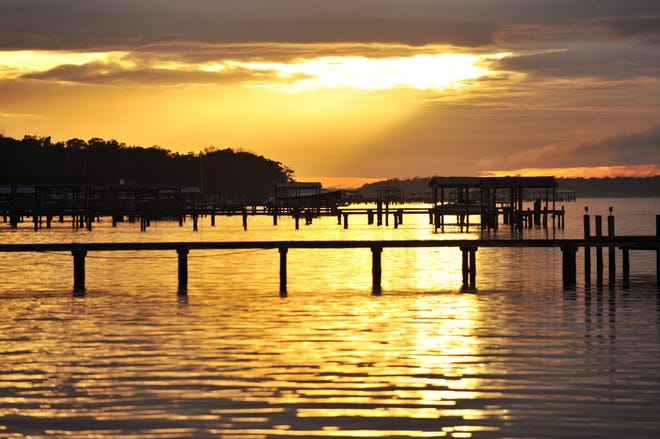 The sun breaks through the clouds over the St. Johns River in Mandarin. [WILL DICKEY/FLORIDA TIMES-UNION]