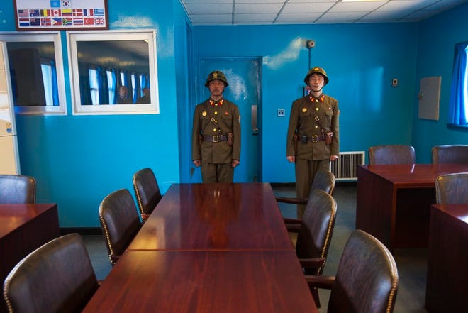 In this 2011 file photo, North Korean soldiers stand guard inside the building shared by North and South Korea at the truce village of Panmunjom at the Demilitarized Zone (DMZ) which separates the two Koreas. The search is on for a venue to host a summit between President Donald Trump and North Korea's Kim Jong Un. There are lots of caveats. Trump is being urged not to legitimize Kim by agreeing to talks in North Korea. And it's risky for Kim to travel to the U.S. So the leaders are more likely to meet in a neutral place, such as the demilitarized zone between the Koreas.