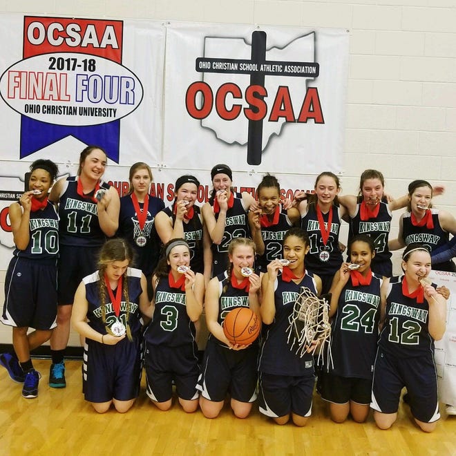 The Kingsway Christian School girls basketball team celebrates with its championship hardware after winning the Ohio Christian School Athletic Association title over Temple Christian last Saturday at Ohio Christian University.