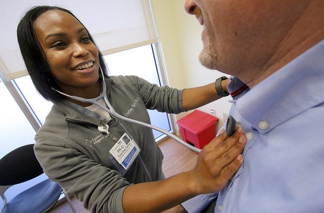 Physician Assistant Courtney Turner, PA-C, checks a patient's heart at CaroMont Urgent Care on Hoffman Road on Friday afternoon, March 2, 2018. [Mike Hensdill/The Gaston Gazette]